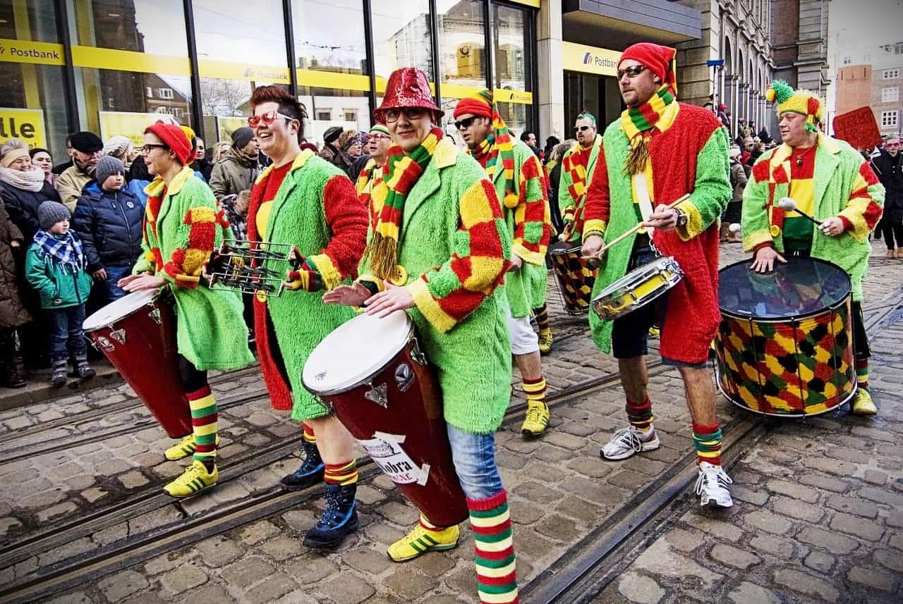 fools marching in a parade dressed like clowns